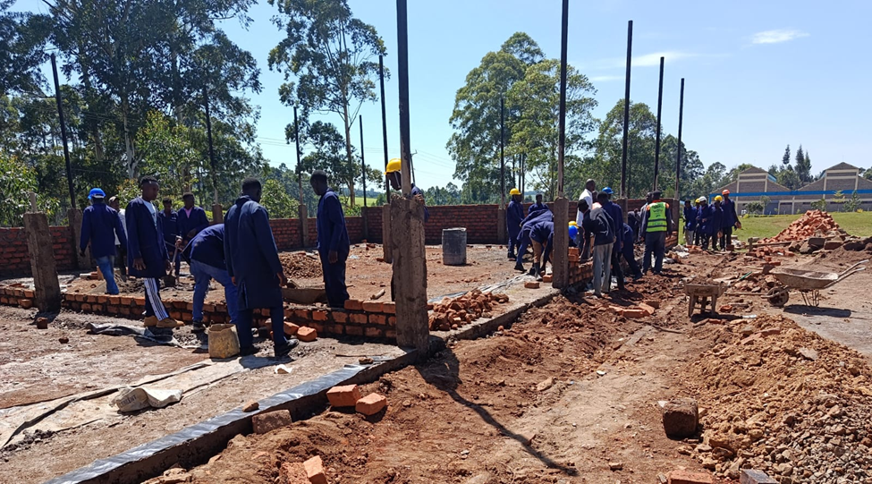 Trainees at Nyamira National Polytechnic construct the institution's Building and Civil Engineering Workshop as part of their training. Photo: State Department for TVET.