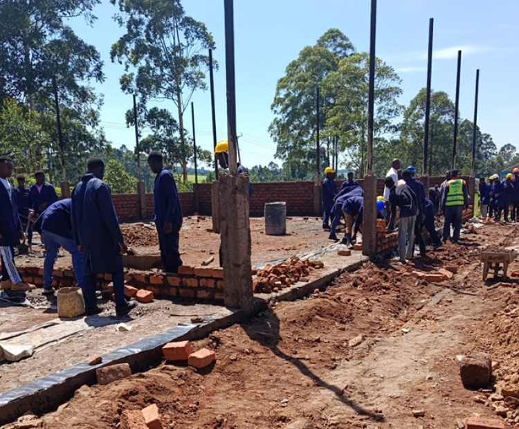 Trainees at Nyamira National Polytechnic construct the institution's Building and Civil Engineering Workshop as part of their training. Photo: State Department for TVET.